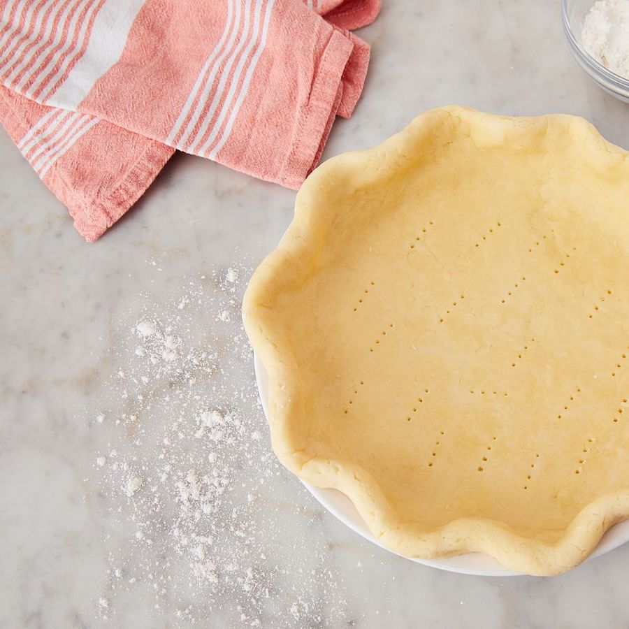Golden brown gluten-free pie crust on a baking tray